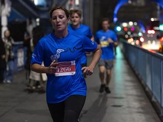 Runner from Run the River 2023 running across Tower Bridge