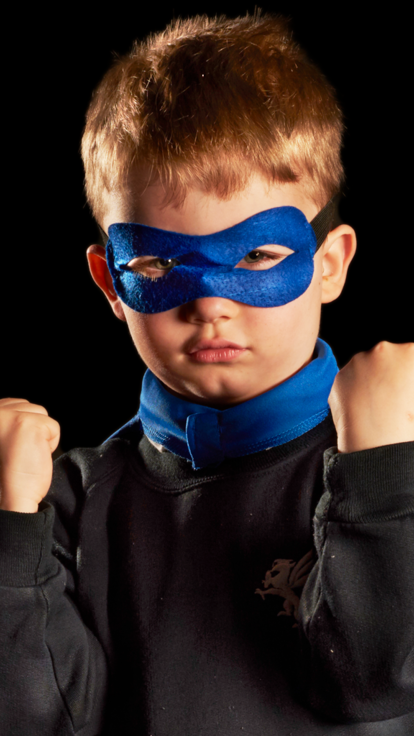 Child poses in superhero costume