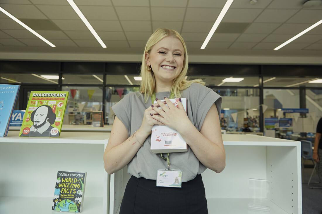 Nancy smiling with a book