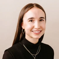 Female with long brown hair smiling 