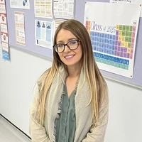 Devon, a SCITT trainee teacher, standing in a classroom.