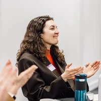 Lauren, a Teach First ambassador, smiling and clapping at an event.