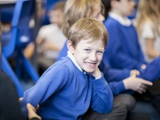young student wearing blue and smiling