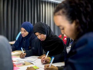 Girl students writing
