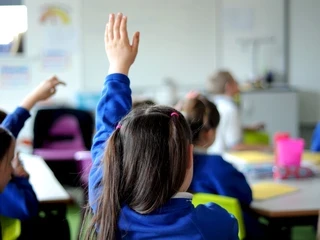 seated student with raised hand