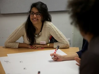 Employee sitting at desk, smiling