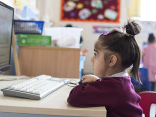 primary school girl using computer
