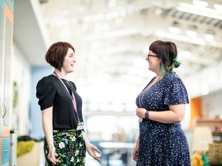 two teachers chat in the classroom