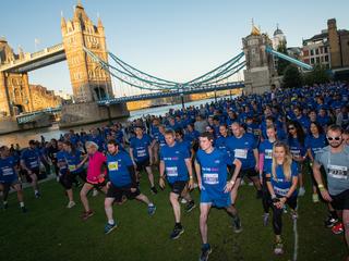 runners near Tower Bridge in London