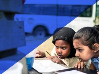 Two primary school girls look intently at a science experiment