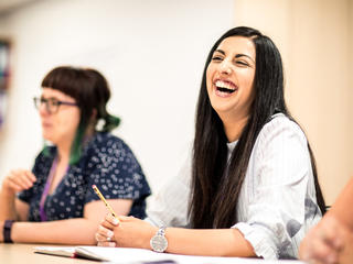 Trainee teacher laughs in training session