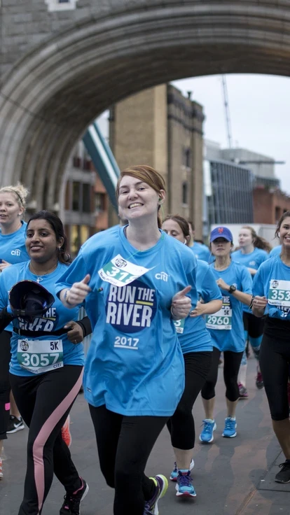 Runners crossing Tower Bridge in London during Run the River