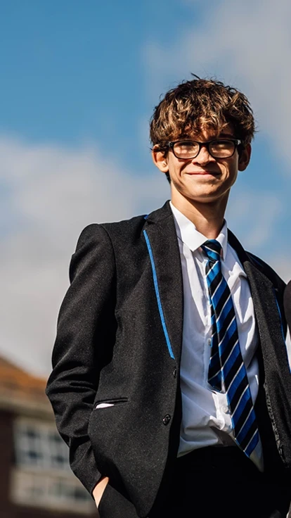 Two students smiling with blue sky background Two students smiling with blue sky background