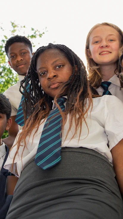 Teach First secondary school students outdoors looking down at the camera