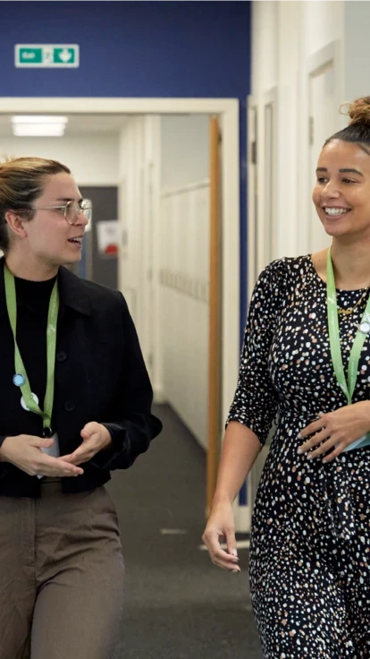 Two female teachers walking through the school hallway