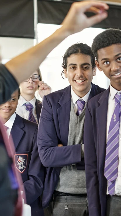 Teacher demonstrating a lesson while students watch in a classroom