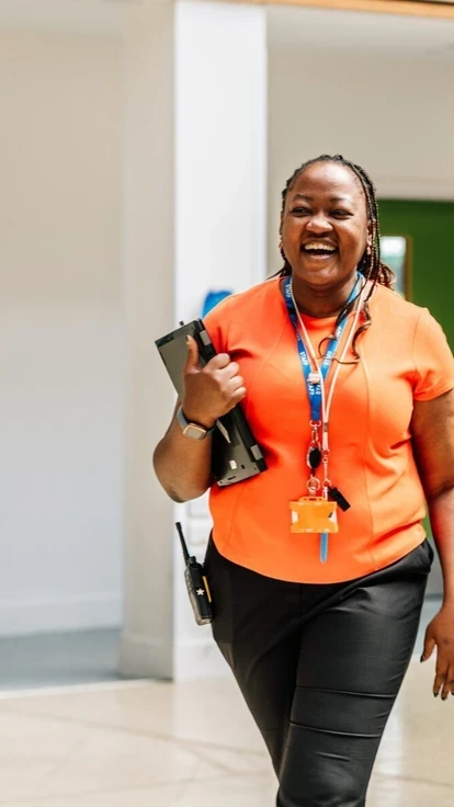 Three staff members walking together in a school setting.