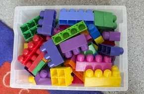 A container of large building blocks used for play-based learning in an early years classroom.